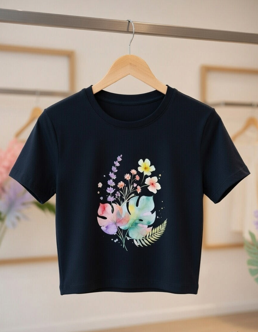 Black t-shirt with colorful elephant and floral design on a hanger